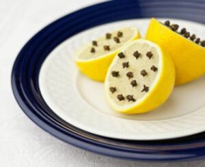 lemon-with-cloves-on-blue-plate