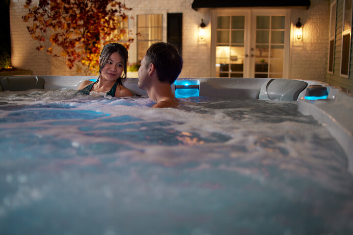 4-person hot tubs - couple enjoying their hot tub at night