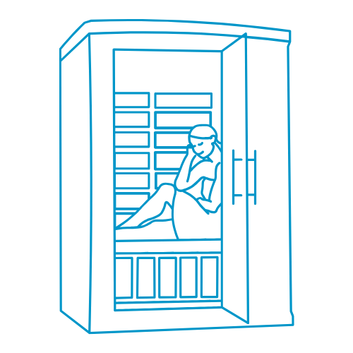 person sitting in a sauna with a towel on relaxing