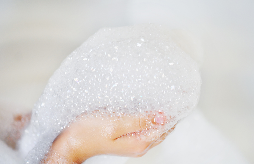 a hand holding a handful of bubbled/foam.