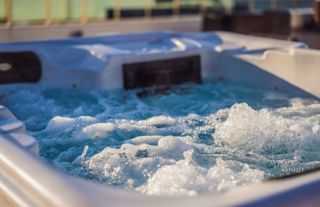a close up of a hot tub with the jets on, creating bubbles and waves in the water.